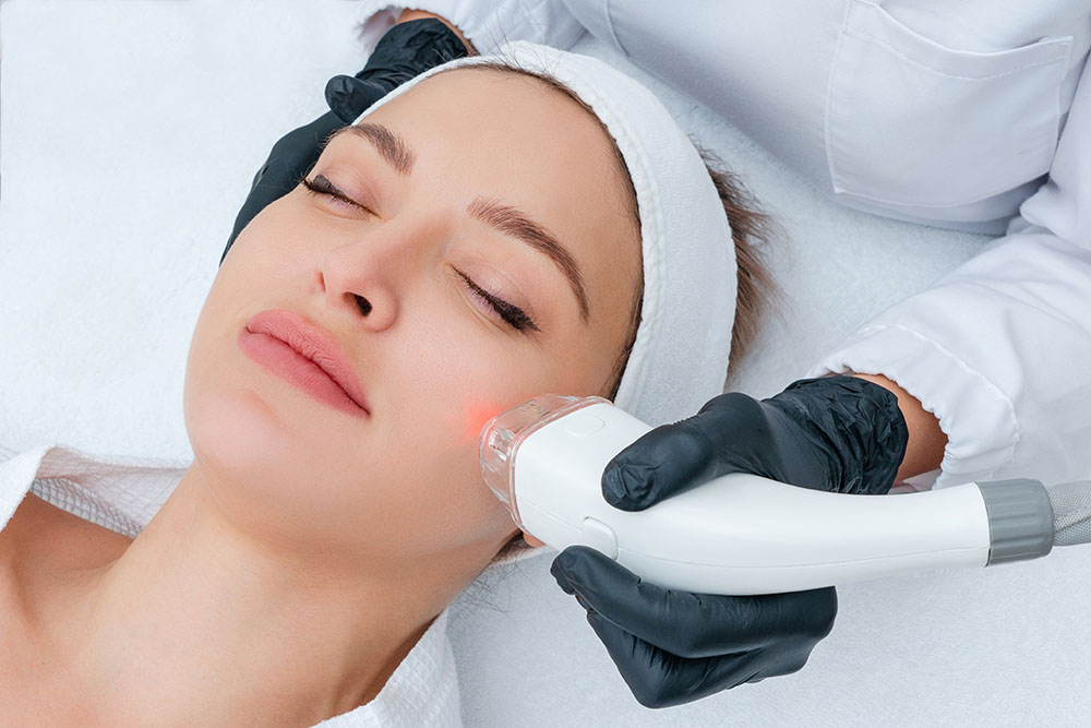 Patient receiving a Pico Glow laser facial at InjectCo as part of a treatment plan
