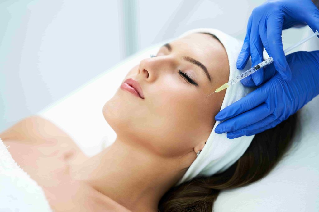 Woman receiving a facial skin treatment at an InjectCo MedSpa clinic in Texas