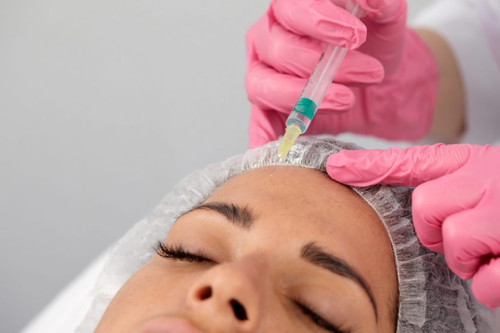 Young woman receiving a preventative Botox injection from a nurse injector at InjectCo MedSpa in Texas
