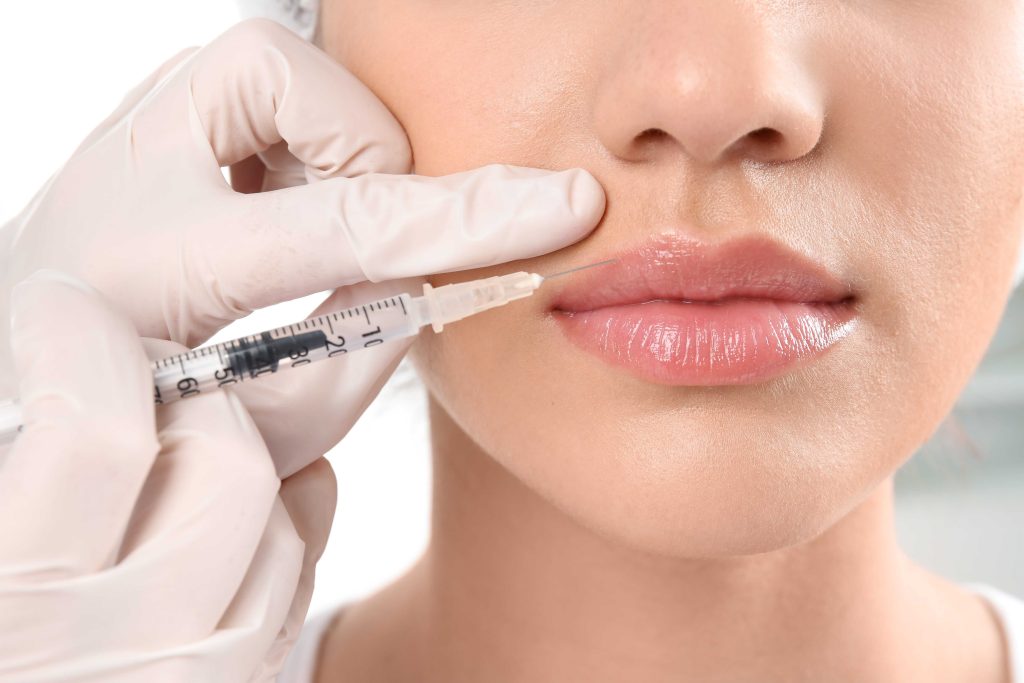 Nurse injector assessing a patient lips before placing hyaluronic acid lip filler