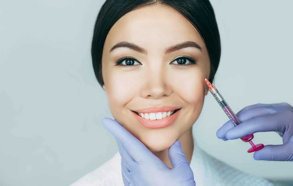 Close up of a nurse injector delivering a precise lip injection at an InjectCo clinic in Texas