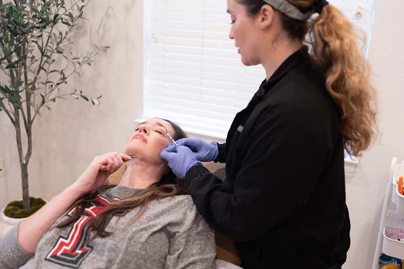 Nurse injector performing a Botox and filler treatment at InjectCo near Haltom City Texas
